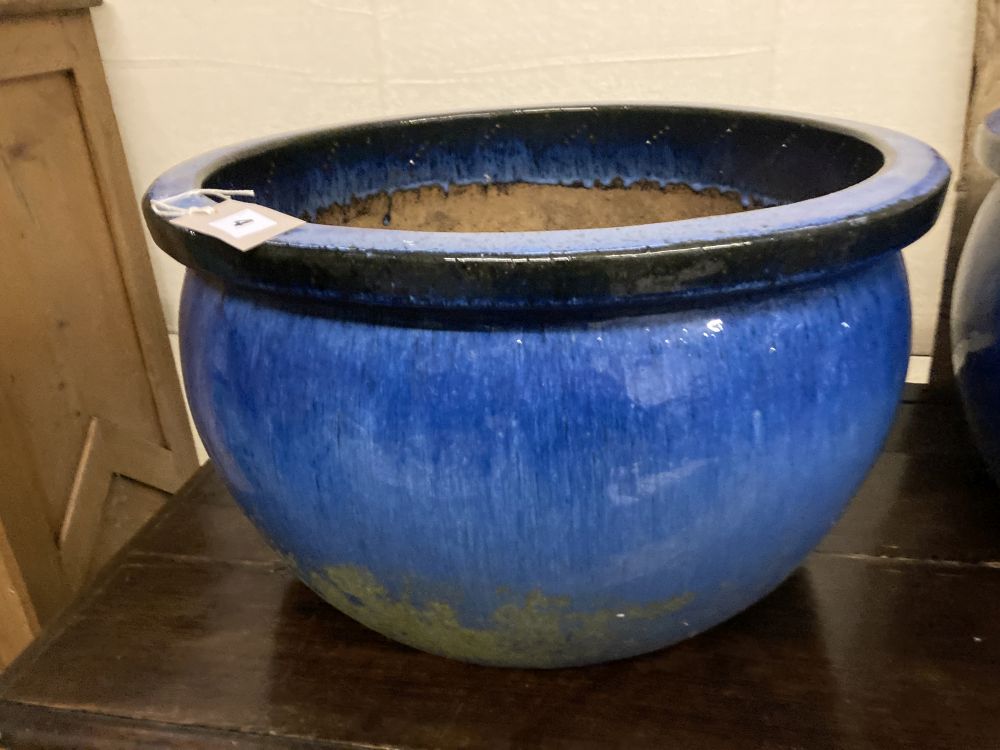 A pair of circular blue glazed garden planters, diameter 52cm, height 30cm